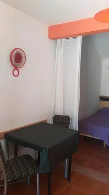 a black table and chairs in a room at Mis Aromos in Mina Clavero
