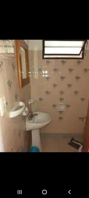 a bathroom with a sink and a mirror at Mis Aromos in Mina Clavero