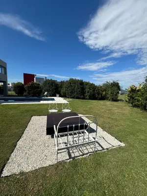 a metal bench sitting on top of a grass field at Casa Calma Puerto del Aguila in Potrero de Garay