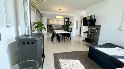 a living room with a couch and a dining room at Casa Calma Puerto del Aguila in Potrero de Garay