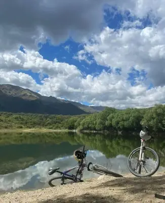 a bike parked on the side of a river at Cabaña dpto en Villa de Merlo in Merlo