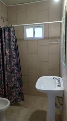 a bathroom with a sink and a shower curtain at Cabaña dpto en Villa de Merlo in Merlo