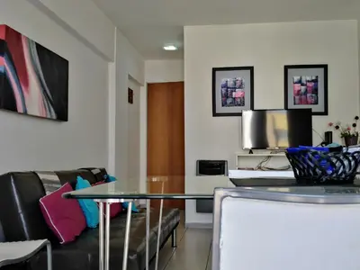 a living room with a table and a couch at Depto En El Centro - Dean Funes in Cordoba