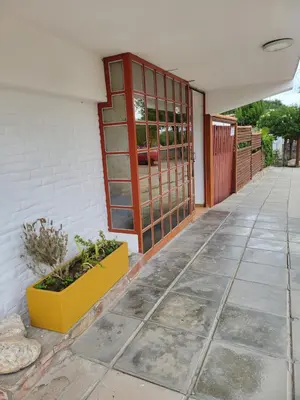 an entrance to a house with a door and a plant at Hotel Car Mar in Mina Clavero