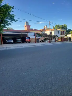 a street with cars parked in front of a building at Hotel Car Mar in Mina Clavero