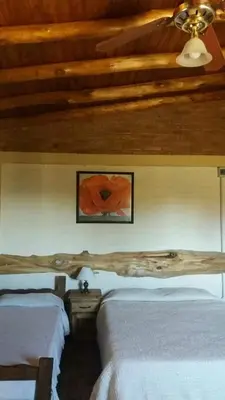 a bedroom with two beds and a wooden ceiling at Nahian in Mina Clavero