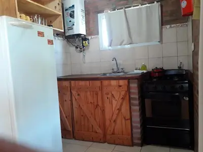 a kitchen with a sink and a stove at Nahian in Mina Clavero