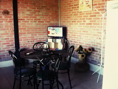 a table with chairs and a computer on top of it at Nahian in Mina Clavero