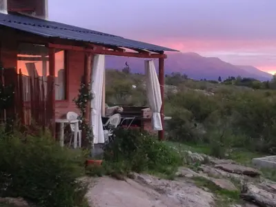 a house with a porch with a table and chairs at Nahian in Mina Clavero
