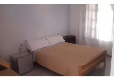a bedroom with a bed and a window at Mis helechos in Mina Clavero