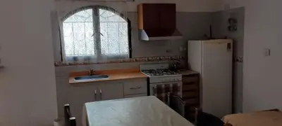 a small kitchen with a sink and a refrigerator at Mis helechos in Mina Clavero