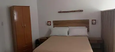 a bedroom with a bed and a wooden headboard at Mis helechos in Mina Clavero