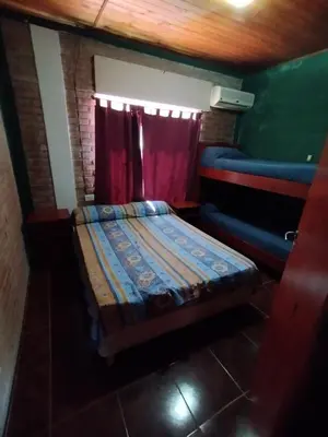 a small room with a bed and a window at Pecas house in Mina Clavero