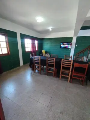 a dining room with a table and chairs at Pecas house in Mina Clavero