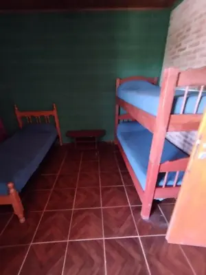 a room with two bunk beds and a bed at Pecas house in Mina Clavero