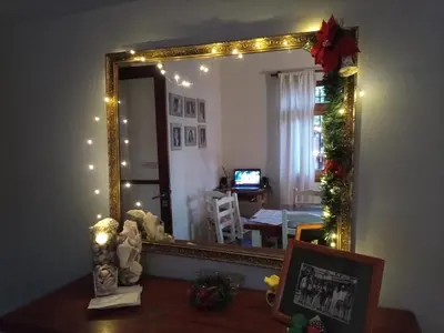 a mirror in a room with christmas lights at La Soleada in Mina Clavero