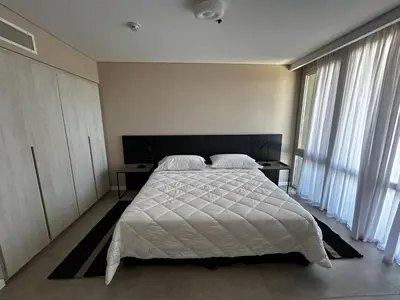 a bedroom with a large white bed and windows at Graciana Residences-Apart in Trapiche