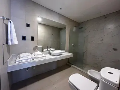 a bathroom with a sink and a toilet and a mirror at Graciana Residences-Apart in Trapiche