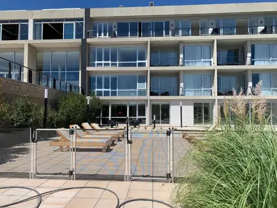 a large building with benches in front of it at Graciana Residences-Apart in Trapiche