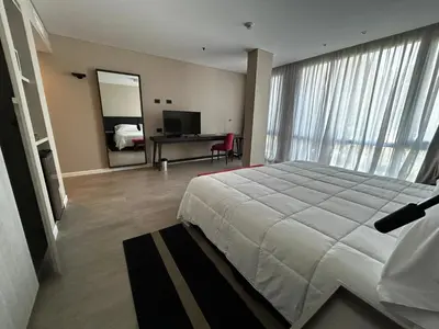 a bedroom with a bed and a desk with a mirror at Graciana Residences-Apart in Trapiche