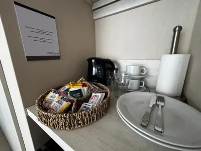 a bathroom counter with a sink and a basket of food at Graciana Residences-Apart in Trapiche