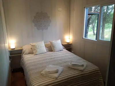 a bedroom with a bed with two towels on it at Casa Cosmos, Apart para parejas in Las Rabonas