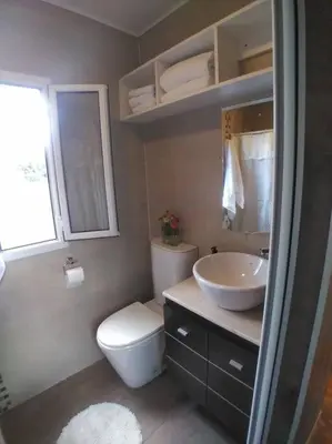 a bathroom with a toilet and a sink at Casa Cosmos, Apart para parejas in Las Rabonas
