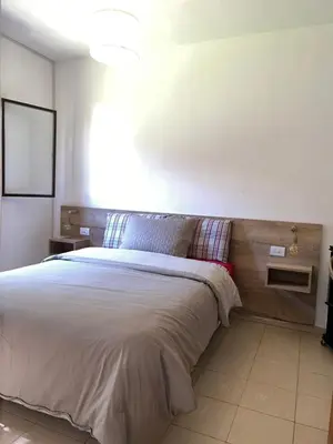 a bedroom with a large bed with a wooden headboard at Córdoba Shopping - ApartQ 3 in Cordoba