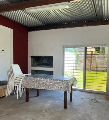 a table in a room with two chairs and a fireplace at Córdoba Shopping - ApartQ 3 in Cordoba