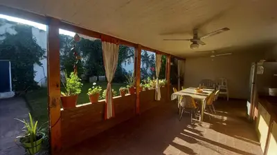 a dining room with a table and some plants at CASA AMPLIA Y CONFORTABLE in Cordoba