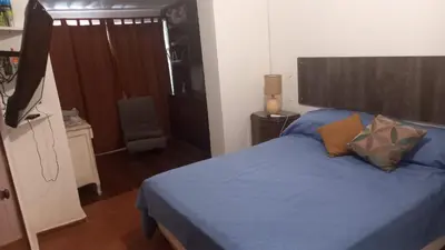 a bedroom with a bed with blue sheets and pillows at CASA AMPLIA Y CONFORTABLE in Cordoba