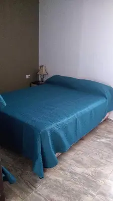 a blue bed with a blue blanket on top of it at el escondido in Villa Cura Brochero