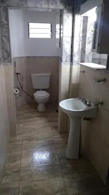 a bathroom with a toilet and a sink at el escondido in Villa Cura Brochero