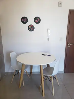 a table and chairs with plates on the wall at ALTOS DE ALEM in Alta Gracia