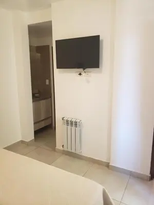 a room with a flat screen tv on a wall at ALTOS DE ALEM in Alta Gracia