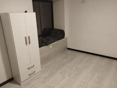 a room with a white refrigerator and a couch at La Mora in Mina Clavero