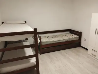 a bedroom with two bunk beds and a ladder at La Mora in Mina Clavero