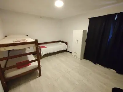 a small room with a bunk bed and a small cabinet at La Mora in Mina Clavero