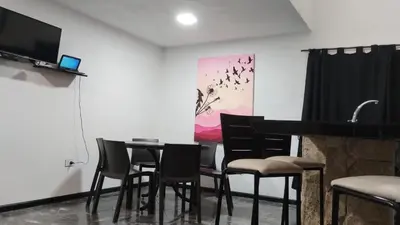 a room with a table and chairs and a piano at La Mora in Mina Clavero