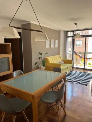 a living room with a table and chairs and a couch at Palacio 210 - Plaza España - Nueva Córdoba - 2 dormitorios in Cordoba