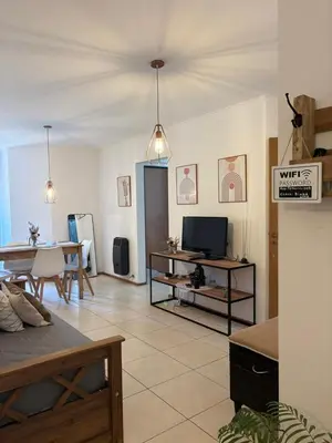 a living room with a tv and a dining room at Departamento Centrico Nueva Cordoba in Cordoba