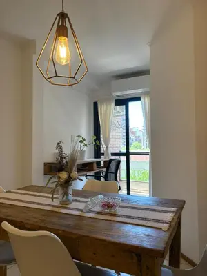 a dining room with a wooden table and chairs at Departamento Centrico Nueva Cordoba in Cordoba