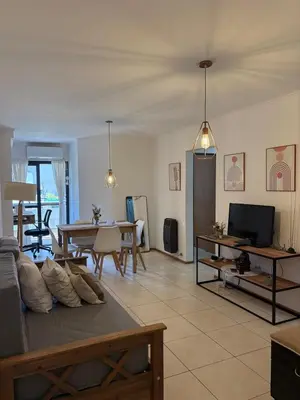 a living room with a couch and a table at Departamento Centrico Nueva Cordoba in Cordoba