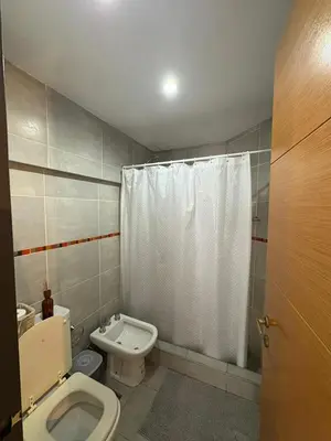 a bathroom with a toilet and a shower curtain at Departamento Centrico Nueva Cordoba in Cordoba