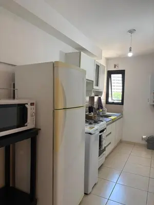 a kitchen with a white refrigerator and a stove at Departamento Centrico Nueva Cordoba in Cordoba