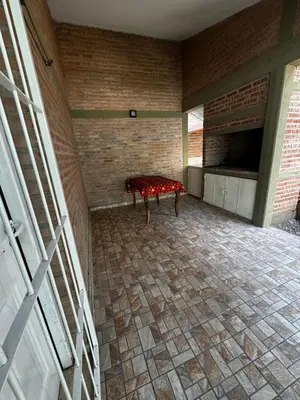 an empty room with a bench in a brick wall at Departamento LAS ARAUCARIAS in Arroyo de Los Patos