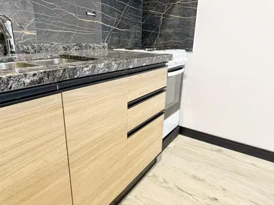 a kitchen with wooden cabinets and a sink at Constantino 6 Apartments in Villa Carlos Paz