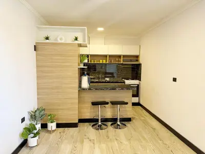 a kitchen with two stools in front of a counter at Constantino 6 Apartments in Villa Carlos Paz