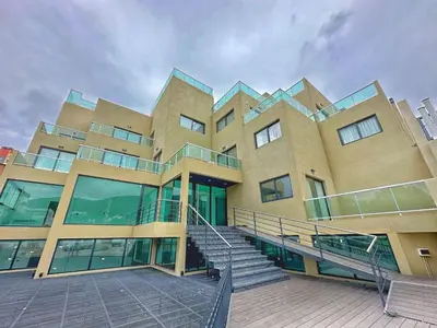 a large building with a staircase in front of it at Constantino 6 Apartments in Villa Carlos Paz