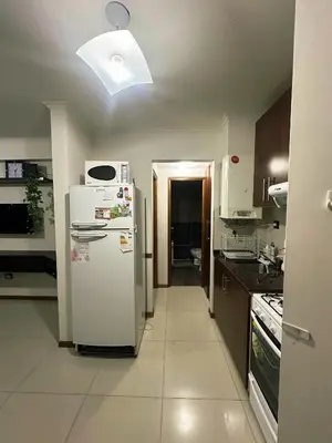 a kitchen with a white refrigerator and a microwave at Apartment Carlos Paz in Villa Carlos Paz